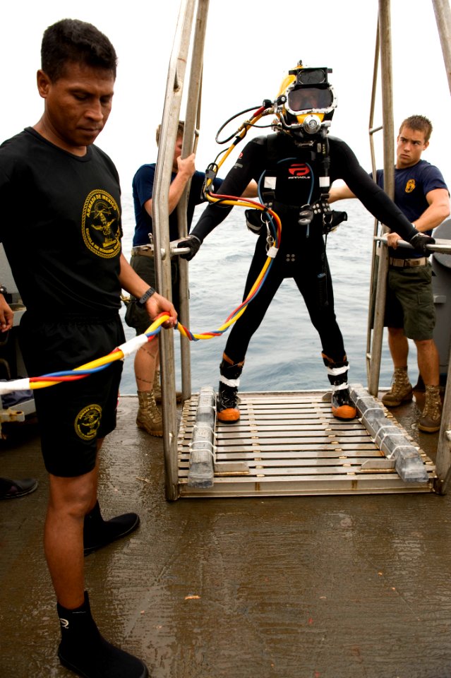 Defense.gov News Photo 100722-N-2831C-005 - U.S. Navy Petty Officer 2nd Class Matthew Wilson assigned to Mobile Diving and Salvage Unit 2 waits to be lowered over the side of the USNS Grasp