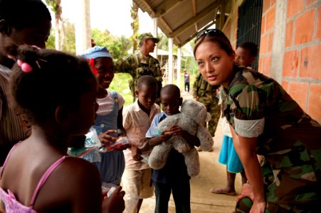 Defense.gov News Photo 100803-N-5319A-140 - U.S. Navy Lt. Marla Metz talks to children about the proper use of the dental supplies they received during a community relations project as part