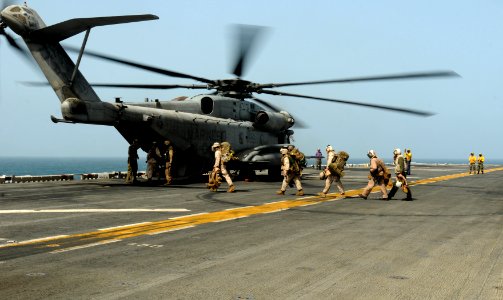 Defense.gov News Photo 100812-N-1226D-050 - U.S. Marines prepare to board a CH-53E Super Stallion helicopter assigned to Helicopter Marine Medium Squadron 165 aboard the USS Peleliu LHA 5 in