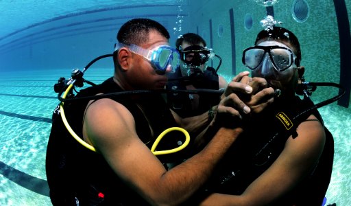 Defense.gov News Photo 100817-N-9769P-178 - Panamanian diver Cpl. Edwin Sanchez left shares his regulator with Cpl. Jamie Berchi right in Panama City Panama on Aug. 17 2010. U.S. Navy