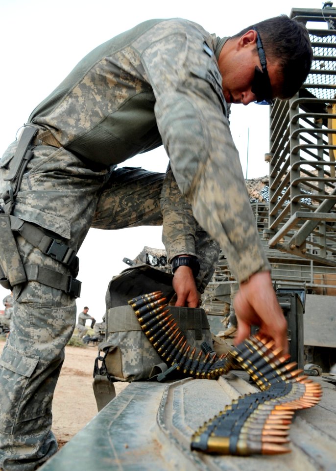 Defense.gov News Photo 100610-N-6903G-010 - U.S. Army Pfc. Jeffrey Brunk Bravo Company 5th Battalion 20th Infantry Regiment 2nd Infantry Division loads ammunition for an M-240B machine