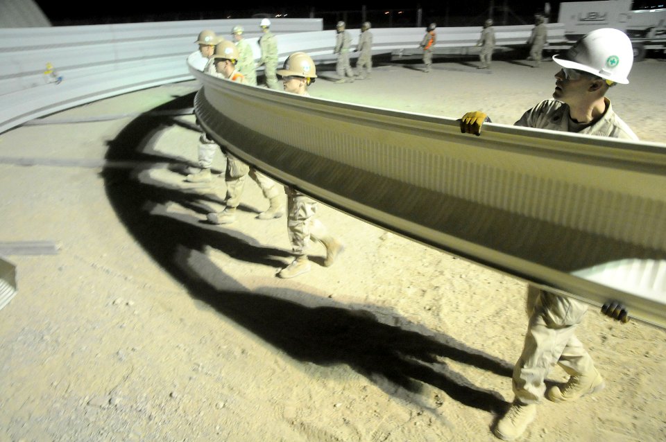 Defense.gov News Photo 100725-N-0475R-196 - U.S. Navy sailors attached to Naval Mobile Construction Battalion 5 move K-Span panels to an assembly area at Camp Leatherneck Afghanistan on