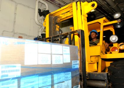 Defense.gov News Photo 100829-N-5969B-024 - U.S. Marine Corps Lance Cpl. Alex Aikens uses a forklift to pick up humanitarian assistance and disaster relief supplies bound for Pakistan in the