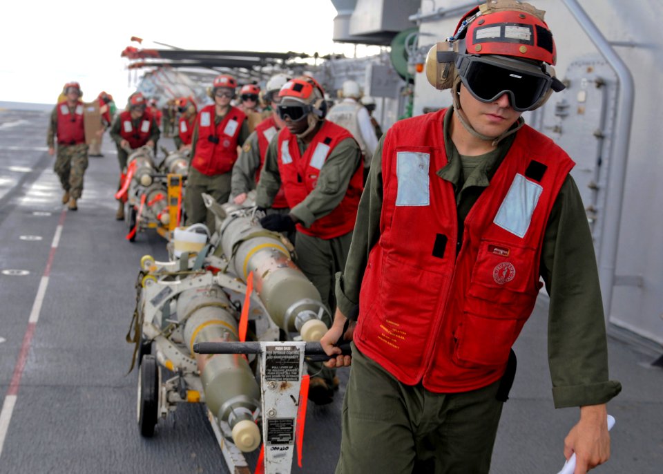 Defense.gov News Photo 100920-N-5538K-042 - U.S. Marines and sailors transport GBU-12 Paveway II laser guided bombs across the flight deck of the amphibious assault ship USS Essex LHD 2 while
