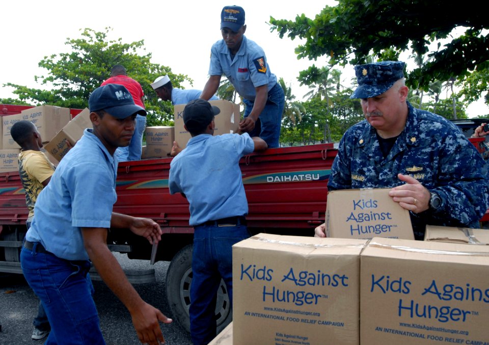 Defense.gov News Photo 100920-N-4971L-095 - U.S. Navy Lt. Cmdr. Ken Cremeans right deputy mission commander for Southern Partnership Station 2010 helps members of the Dominican Republic s