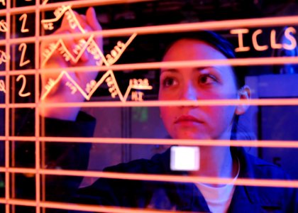 Defense.gov News Photo 100921-N-9950J-163 - U.S. Navy Airman Chelsea Pitchford updates information on an aircraft status board in the amphibious air traffic control center aboard the
