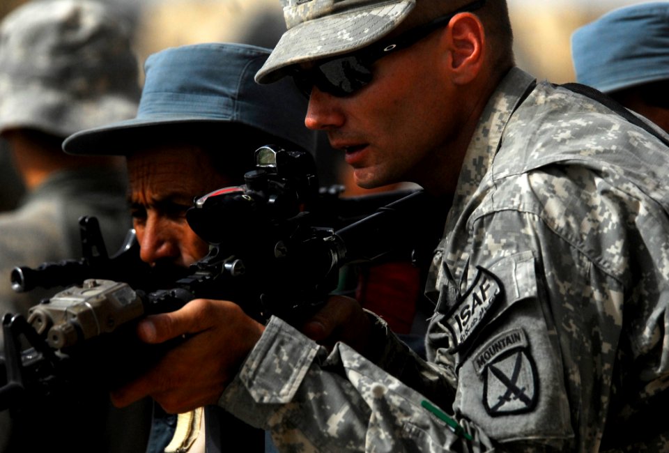 Defense.gov News Photo 100828-N-6538W-084 - U.S. Army Sgt. James Henderson right of the 1st Battalion 87th Infantry Regiment 10th Mountain Division assists an Afghan National Police officer