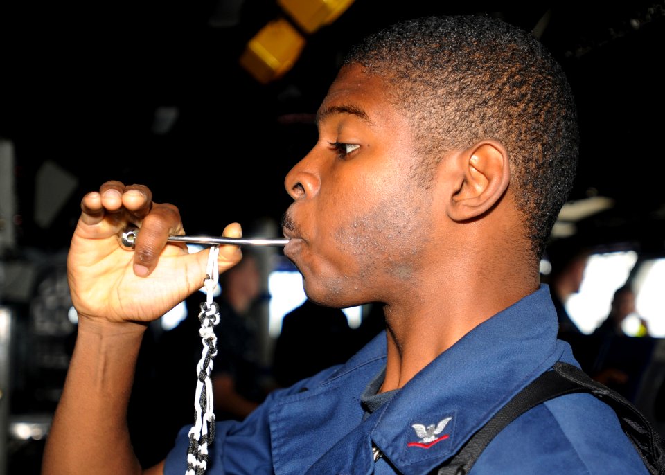 Defense.gov News Photo 100904-N-5969B-006 - U.S. Navy Boatswain s Mate 3rd Class Aaron Shorts pipes the mess call into the main public address circuit aboard the amphibious assault ship USS