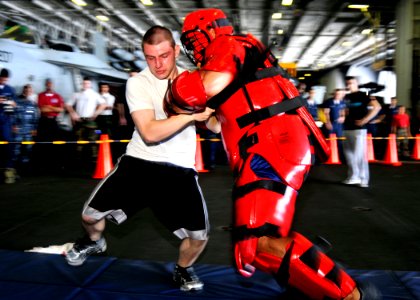Defense.gov News Photo 100926-N-7103C-005 - U.S. Navy Airman Kyle Babcock performs a defensive strike technique after being sprayed with oleoresin capsicum also known as pepper spray aboard