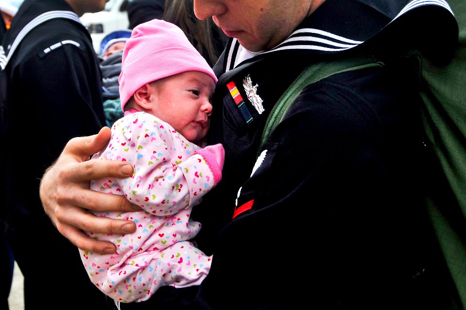 Defense.gov News Photo 101101-N-7103C-192 - U.S. Navy Petty Officer 3rd Class Matthew Sandlin holds his newborn daughter for the first time after being underway for six months aboard the
