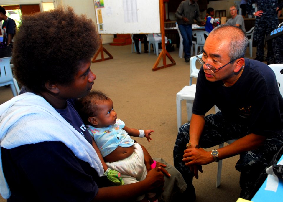 Defense.gov News Photo 100904-N-4044H-041 - U.S. Navy Cmdr. Mark Nguyen right embarked aboard the Royal Australian Navy landing ship heavy HMAS Tobruk L 50 consults with a patient during a