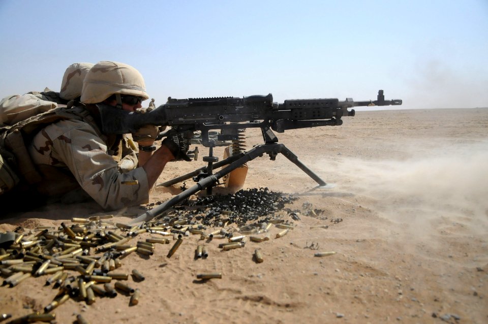 Defense.gov News Photo 101016-N-0475R-687 - U.S. Petty Officer 3rd Class Justin Winters a Seabee attached to Naval Mobile Construction Battalion 5 fires an M-240B machine gun during