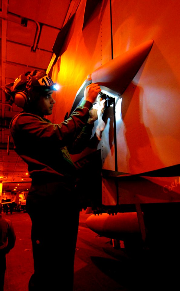 Defense.gov News Photo 101201-N-7422B-037 - Petty Officer 3rd Class Quinones Ortiz assigned to Strike Fighter Squadron 22 cleans corrosion from the ball bearings of an F A-18 Super Hornet