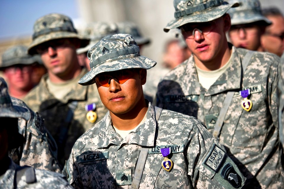 Defense.gov News Photo 101216-N-0696M-113 - U.S. Army Spc. Charles Parno left Sgt. Gabriel Meza center and Pfc. Brian Marcey stand in formation after receiving their Purple Hearts from
