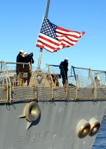 Defense.gov News Photo 101215-N-5292M-108 - Sailors aboard the guided-missile destroyer USS Stout DDG 55 remove the national ensign as the ship pulls away from the pier at Naval Station