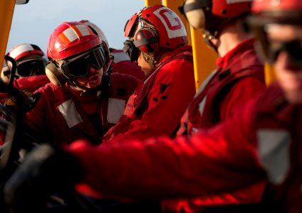Defense.gov News Photo 101228-N-7981E-026 - U.S. Navy Petty Officer 2nd Class Anthony Hedgepeth 2nd from left directs other sailors as they prepare to move ordnance during a vertical