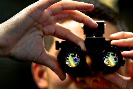 Defense.gov News Photo 110106-N-2055M-063 - U.S. Navy Seaman Garrick Hague adjusts a set of night-vision goggles inside an intermediate maintenance shop aboard the aircraft carrier USS Carl