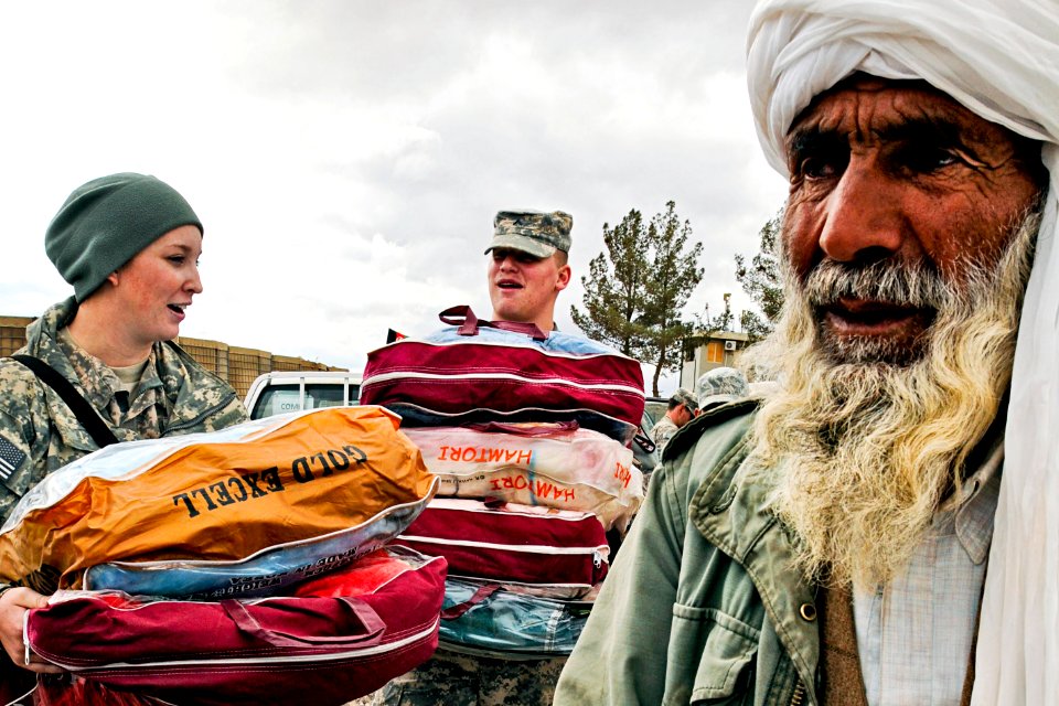 Defense.gov News Photo 110202-N-2142H-001 - U.S. forces help distribute blankets coats wool caps and scarves to local village elders in Shindand in Afghanistan s Herat province on Feb. 2
