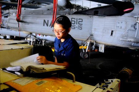 Defense.gov News Photo 110213-N-OK922-036 - U.S. Navy Airman Tracey Gonzales performs maintenance on a mobile electric power plant in the hangar bay of the aircraft carrier USS Carl Vinson