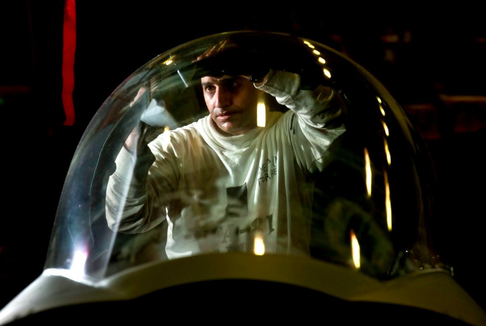 Defense.gov News Photo 110219-N-DR144-070 - U.S. Navy Petty Officer 3rd Class Oswaldo Torres installs a pressure seal in the canopy of an F A-18E Super Hornet in the hangar bay aboard the