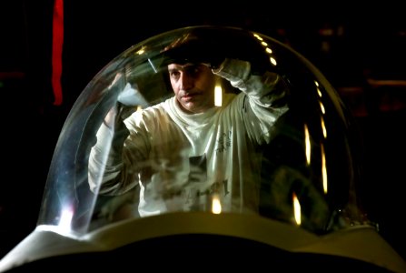 Defense.gov News Photo 110219-N-DR144-070 - U.S. Navy Petty Officer 3rd Class Oswaldo Torres installs a pressure seal in the canopy of an F A-18E Super Hornet in the hangar bay aboard the