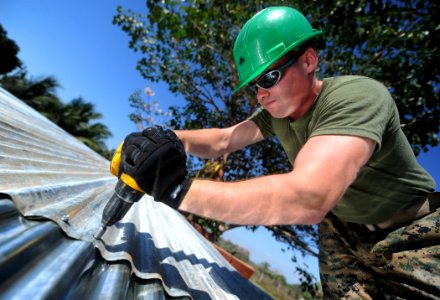 Defense.gov News Photo 110131-N-2984R-220 - U.S. Marine Corps Lance Cpl. Stephen S. Mcdonaldhale assigned to the 2nd Marine Logistics Group repairs the roof of a classroom at Escuela Santa photo