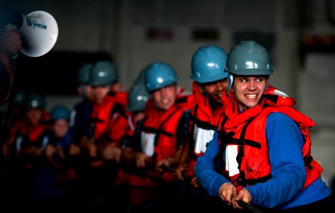 Defense.gov News Photo 110202-N-2055M-224 - Sailors heave a line inside the hangar bay aboard the aircraft carrier USS Carl Vinson CVN 70 during a replenishment at sea in the Arabian Sea on