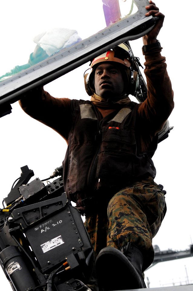 Defense.gov News Photo 110205-N-0232G-022 - U.S. Marine Corps Cpl. Shannon Tyler assigned to Marine Fighter Attack Squadron 323 cleans the canopy of an F A-18C Hornet aircraft on the flight