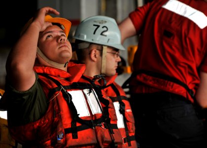 Defense.gov News Photo 101216-N-5016P-094 - Petty Officer 3rd Class Edwin Pastrana looks up while waiting to help receive stores during a replenishment at sea aboard the aircraft carrier USS