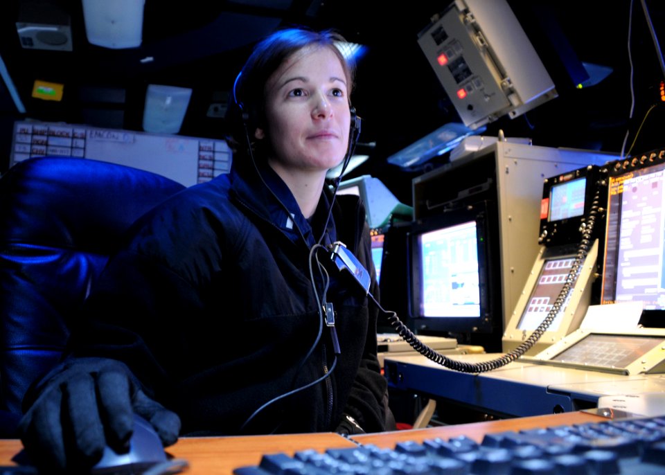 Defense.gov News Photo 110304-N-SG869-010 - U.S. Navy Lt. j.g. Sara Everett a Combat Direction Center watch officer reviews intelligence slides aboard the aircraft carrier USS Ronald Reagan