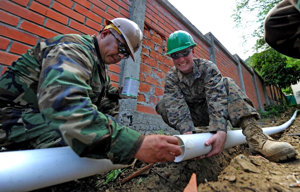 Defense.gov News Photo 110105-N-7589W-087 - U.S. Navy Petty Officer 1st Class Carlos Sanchez left assigned to Naval Mobile Construction Battalion 28 Detail Bravo applies concrete sealant photo