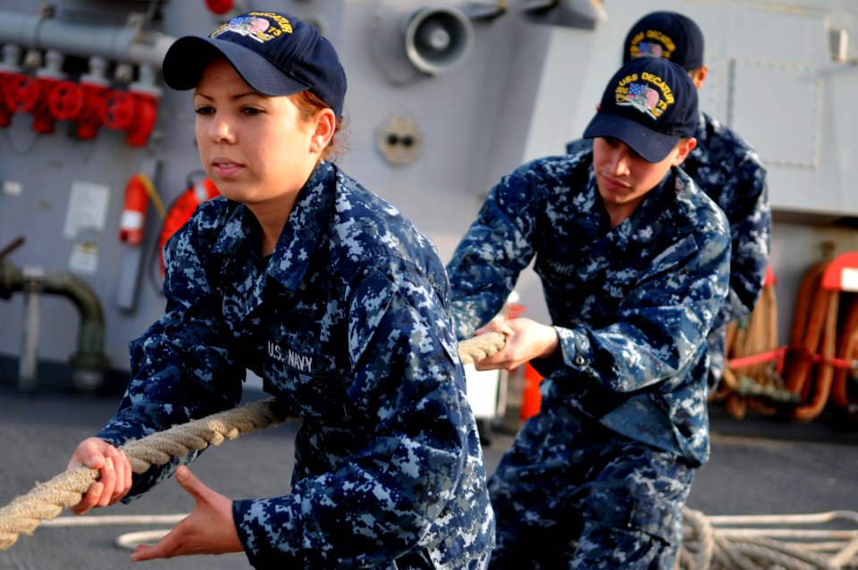 Defense.gov News Photo 110309-N-9818V-229 - Seaman Erika Berry and Seaman Robert Toohey heave a line during sea and anchor detail aboard the guided-missile destroyer USS Decatur DDG 73 near