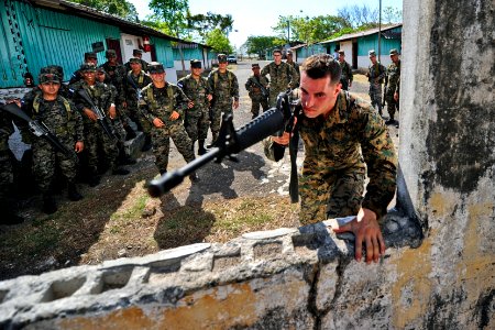 Defense.gov News Photo 110315-N-EC642-756 - U.S. Marine Sgt. Michael G. Roth demonstrates proper building entry techniques to soldiers assigned to 11th Honduran Army Battalion during a photo