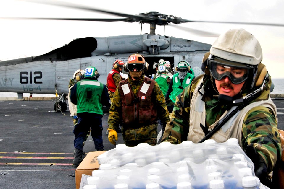 Defense.gov News Photo 110319-N-DM338-068 - U.S. sailors and Marines aboard the aircraft carrier USS Ronald Reagan load humanitarian assistance supplies onto an HH-60H Seahawk helicopter
