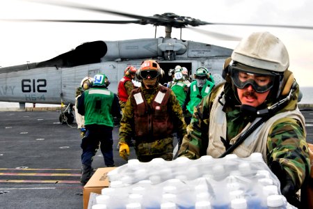 Defense.gov News Photo 110319-N-DM338-068 - U.S. sailors and Marines aboard the aircraft carrier USS Ronald Reagan load humanitarian assistance supplies onto an HH-60H Seahawk helicopter