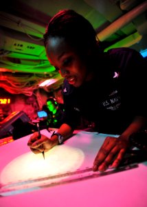 Defense.gov News Photo 110308-N-0569K-048 - Petty Officer 3rd Class Lakysha Brown uses the dead reckoning tracer to plot the ship s course and speed in the commanding officer s tactical plot