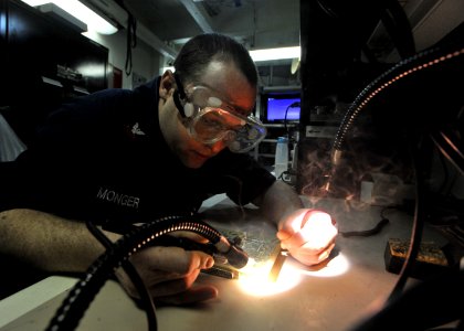Defense.gov News Photo 110326-N-0569K-068 - Petty Officer 2nd Class Christopher M. Monger repairs circuit cards aboard the aircraft carrier USS Enterprise CVN 65 underway in the Arabian Sea