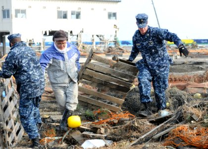 Defense.gov News Photo 110314-N-MU720-059 - Chief Petty Officer Kyle Wilkinson right from Baldwinsville N.Y. assigned to Naval Air Facility Misawa helps remove debris during a cleanup