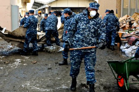 Defense.gov News Photo 110317-N-MU720-019 - U.S. Navy Petty Officer 2nd Class Robert Bannister removes mud sediment from behind a damaged building in Hachinohe Japan on March 17 2011