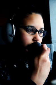 Defense.gov News Photo 110223-N-IC111-006 - U.S. Navy Seaman Recruit Meriah Encarnacion relays information to the bridge while on look out from the fantail of the aircraft carrier USS Ronald