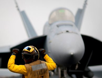 Defense.gov News Photo 110405-N-DR144-192 - Airman Tamara Sewell directs an F A-18E Super Hornet aircraft aboard the aircraft carrier USS Carl Vinson CVN 70 underway in the Arabian Gulf on