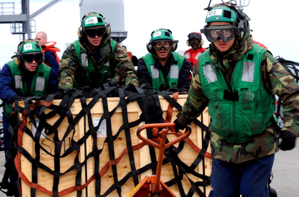 Defense.gov News Photo 110321-N-4031K-557 - Petty Officer 2nd Class Shizhen Huang right assigned to Light Helicopter Anti-Submarine Squadron 51 pulls a pallet of supplies to the flight