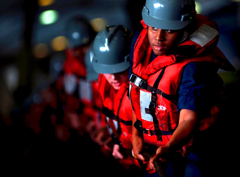 Defense.gov News Photo 110225-N-2055M-058 - U.S. Navy sailors man a line in the hangar bay aboard the aircraft carrier USS Carl Vinson CVN 70 during a replenishment in the Arabian Sea on Feb