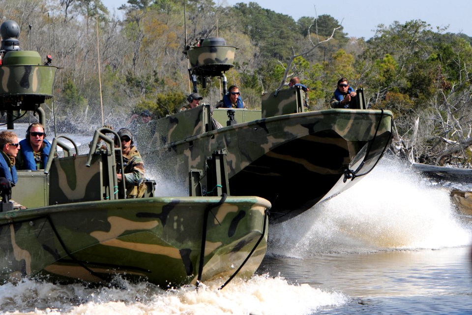 Defense.gov News Photo 110322-N-YO394-098 - Sailors assigned to Riverine Squadron 3 and marines from the Royal Netherlands marine corps perform a right echelon maneuver in riverine assault