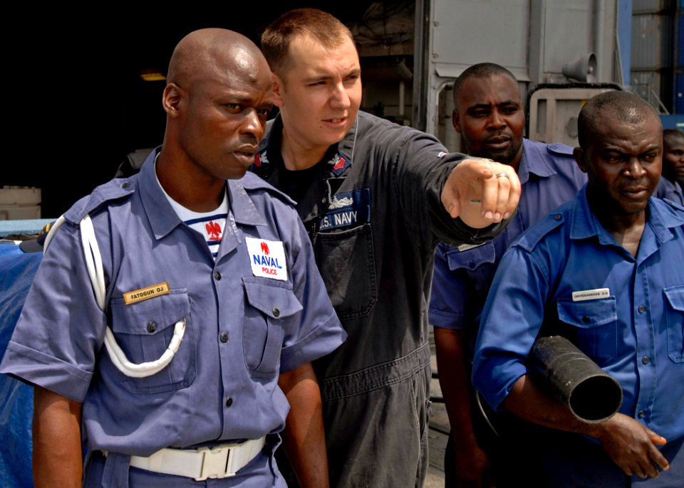 Defense.gov News Photo 110411-N-HI707-410 - U.S. Navy Petty Officer 1st Class Eric Bel 2nd from left instructs a member of the Nigerian Naval Police on firefighting methods during a damage