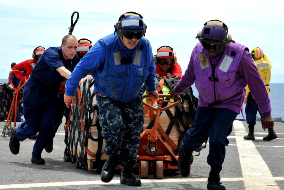 Defense.gov News Photo 110312-N-CP762-2100 - U.S. Navy sailors aboard the U.S. 7th Fleet flagship USS Blue Ridge LCC 19 move pallets of humanitarian assistance disaster relief kits across the