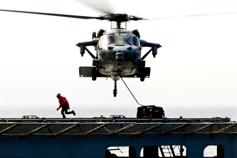 Defense.gov News Photo 110315-N-5538K-200 - An MH-60S Seahawk helicopter transports humanitarian assistance supplies from the Military Sealift Command dry cargo and ammunition ship USNS