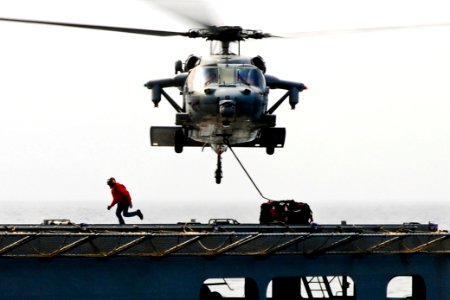 Defense.gov News Photo 110315-N-5538K-200 - An MH-60S Seahawk helicopter transports humanitarian assistance supplies from the Military Sealift Command dry cargo and ammunition ship USNS