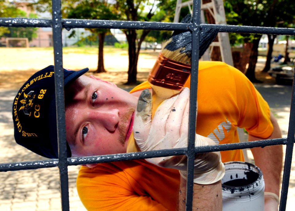 Defense.gov News Photo 110503-N-RG360-070 - U.S. Navy Petty Officer 2nd Class Jason Barcellos paints part of the Muang Phuket School in Chalong Thailand during a community service project