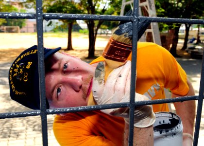 Defense.gov News Photo 110503-N-RG360-070 - U.S. Navy Petty Officer 2nd Class Jason Barcellos paints part of the Muang Phuket School in Chalong Thailand during a community service project